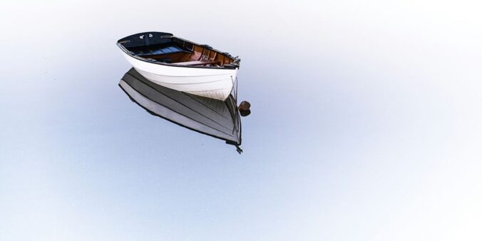 white boat on body of water