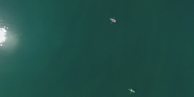 aerial photography of two boats on body of water